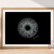 Framed print of a single blue-grey iris on black with a handwritten name
