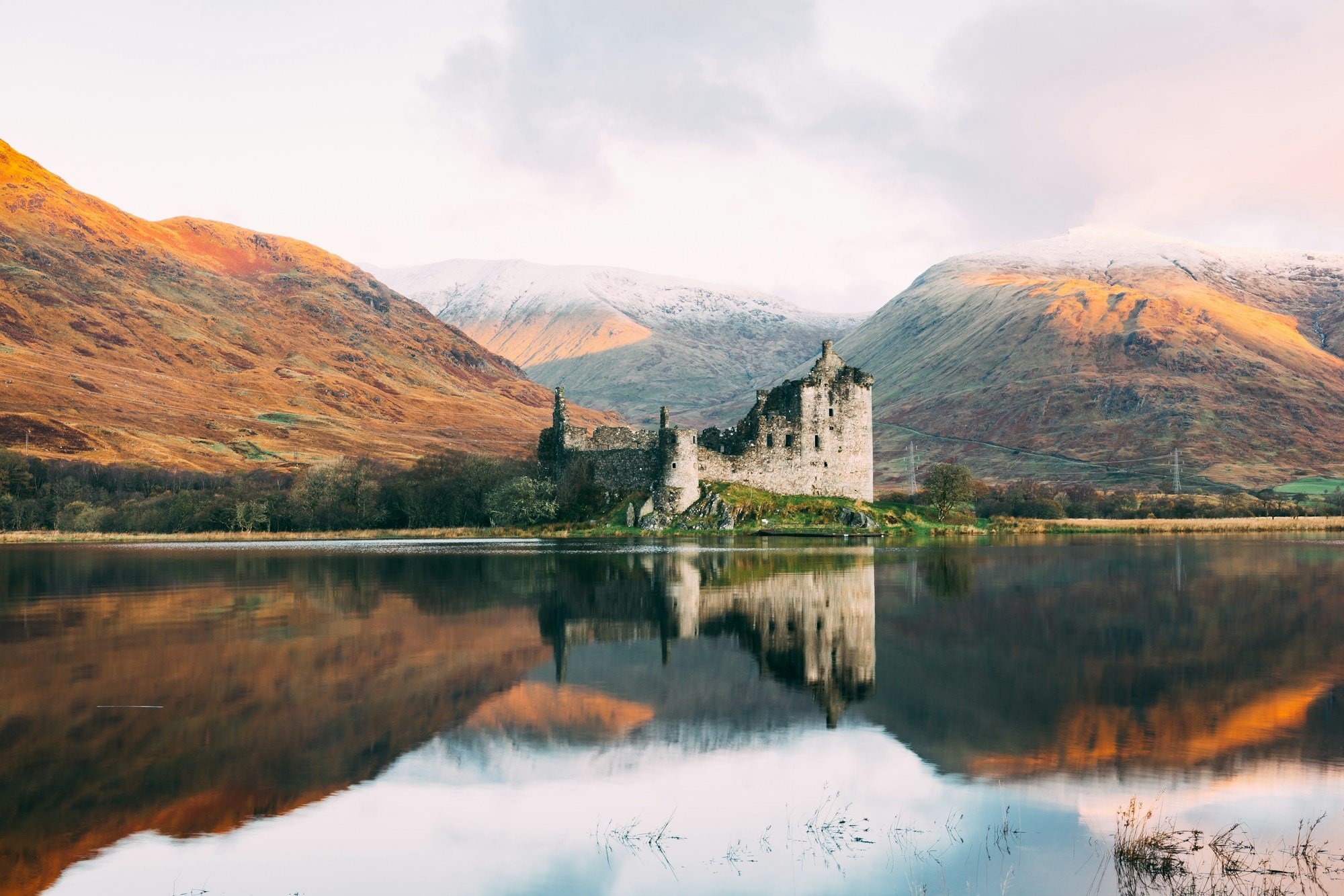 Kilchurn Castle ruins reflected in the still water of Loch Awe